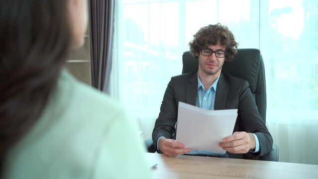 good looking Asian young woman having a job interviewing with the senior managing director in meeting room.