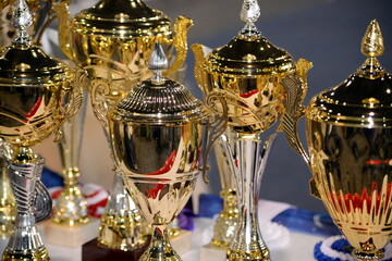Beautiful golden trophies close up photography. Gold award prize. First winner.