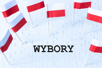 Polish white and red flags and the inscription WYBORY, meaning elections in English, Concept, Elections in Poland, encouragement to vote - obrazy, fototapety, plakaty