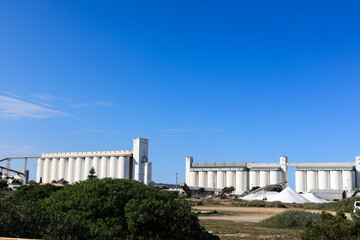Thevenard Port salt piles and silos against blue sky