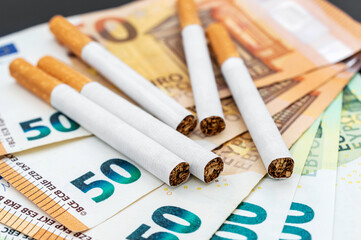 Cigarettes on the euro bills. Close up.