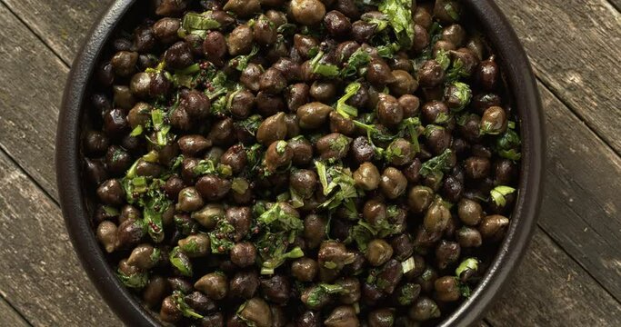 Green Chickpea Chaat or Harbara Chat, popular snack from India. Top view. Table spin.