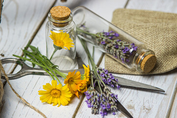 Flowers in a glass flask on a wooden table