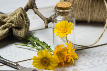 Flowers in a glass flask on a wooden table