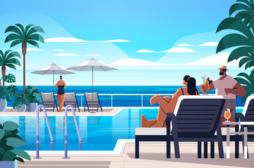 people relaxing at tropical luxury resort hotel beach swimming pool and poolside seating area summer vacation concept
