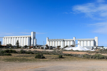 Thevenard Port salt piles and silos against blue sky