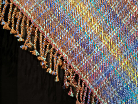 Latvian traditional hand-woven yellow blue red colored wool blanket corner with fringes