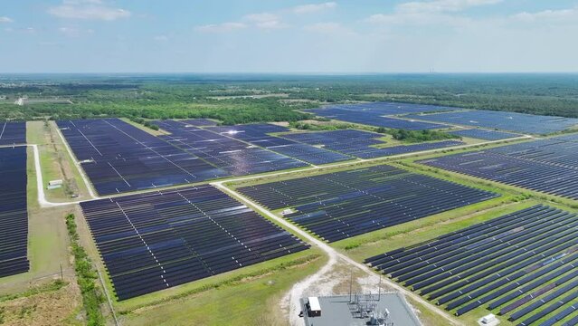 Aerial view of large sustainable electrical power plant with rows of solar photovoltaic panels for producing clean electric energy. Concept of renewable electricity with zero emission