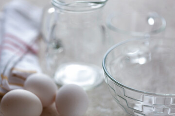 Background of bakery ingredients and utensils, eggs, milk bowls