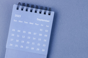 The September 2023 Monthly desk calendar for 2023 year on blue background.