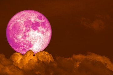 super pink Beaver Moon back dark heap cloud on the night sky
