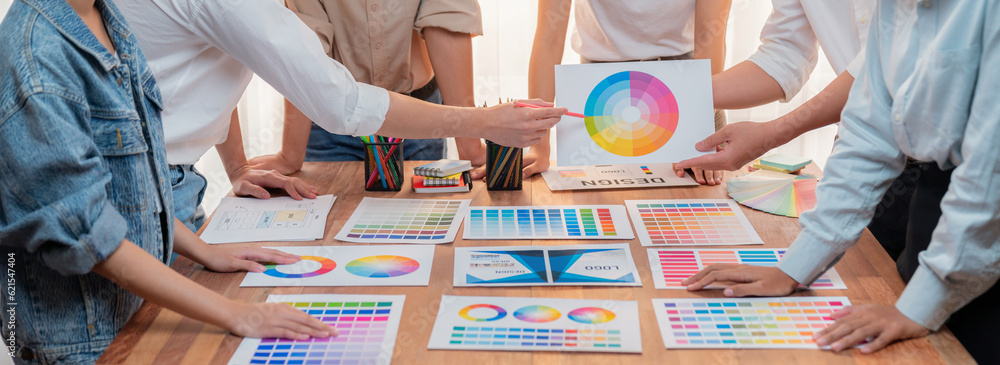 Aufkleber Graphic designer brainstorm logo and graphic art at busy creative studio workshop. Experiment and brainstorm color palette and pattern at workspace table for creative design. Panorama shot. Scrutinize