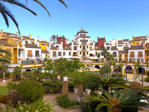 beautiful park and garden with palm trees in the centrum of La Alcaidesa with nice colorful houses, C&aacute;diz, Andalusia, Malaga, Spain