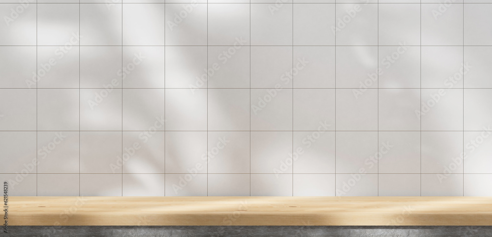 Aufkleber wooden table countertop and white tile wall background with sunlight. windows and leafs shadows summ