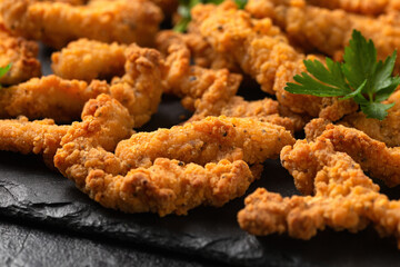 Crispy Shredded Chicken with sweet chilli sauce served on black slate. Party finger food snack concept