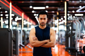 Energetic Fitness Sportsman at Gym. Asian Man Athlete Crosses Arms. Handsome Guy Smart and Confidence in Fitness Center