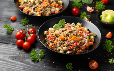 Red and white quinoa tabbouleh salad with tomatoes, paprika and mint. Vegetarian, vegan food concept