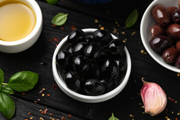 Assortment of fresh green, kalamata and black olives in bowl. Healthy snack
