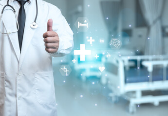 Obraz na płótnie Canvas Doctor in lab coat is showing thumb up on background in hospital interior. Medical concept. Medical information search concept. The concept of treating disease. insurance concept
