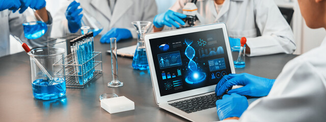 Dedicated scientist group working on advance biotechnology computer software to study or analyze DNA data after making scientific breakthrough from chemical experiment on medical laboratory. Neoteric - obrazy, fototapety, plakaty