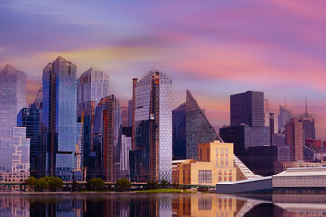 Abstract view of waterfront, downtown skyline at dusk with skyscrapers over Hudson River,