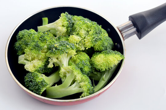 Healthy Green Organic Raw Broccoli ready to cook. Raw broccoli at frying pan