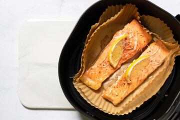Tasty cooked salmon steak with lemon. Healthy and easy meals from air fryer.