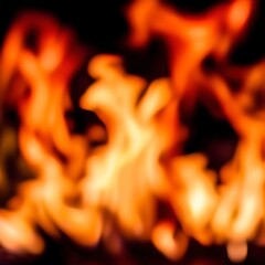 Frame of blurred bright burning hot fire flames against black background