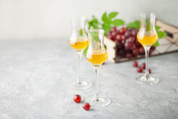 Grape vodka. Strong alcoholic drink in glasses on the table. Fresh grapes