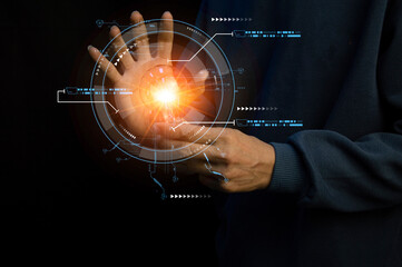 Close up of the hand of a person holding a bright light bulb in black background. Idea, innovation, idea and inspiration for business concept. cyber digital data concept