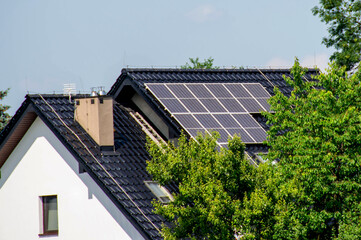 Fototapeta premium House roof with photovoltaic modules.