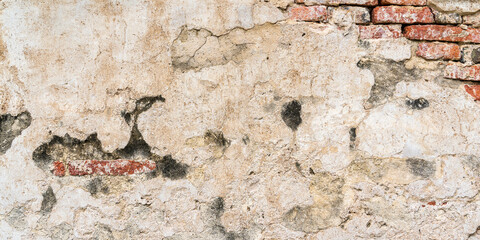Fototapeta premium Old brick wall with plaster peeling off, grunge background. concrete for editing text on blank spaces, backdrops, banners, abstracts.