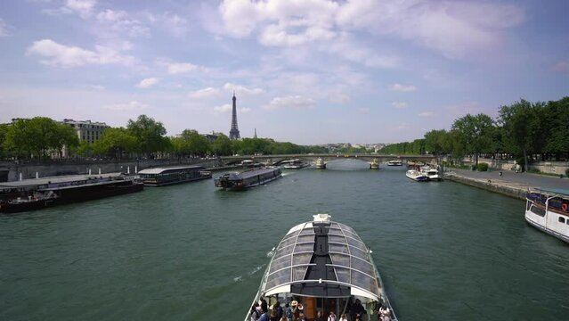 Paris, France - May 2023: Pont Alexandre III bridge and Eiffel Tower seen from a Bateau Mouche tour boat cruising on the Seine river in Paris, France. High quality 4k footage