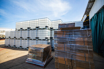 Folded cardboard boxes in the warehouse. Stack of flat industrial folding cardboard