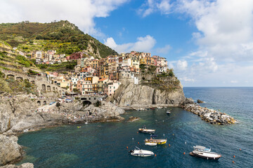 Fototapeta na wymiar Scenic view of Manarola village, one of the five villages along Cinque Terre hiking trail in Italy, popular as tourist destination