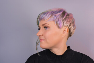 Portrait of an adult girl Caucasian cute with a stylish hairstyle colored bob on a studio background