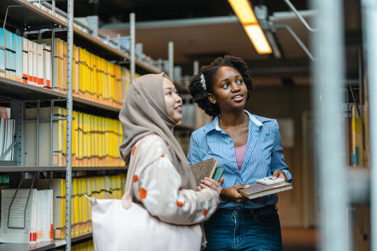 Female students standing together in university library