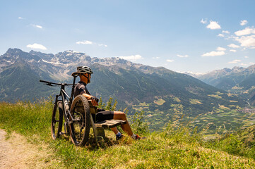 Cyclist in the Alps. - obrazy, fototapety, plakaty
