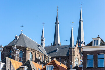Netherlands, Delft, helicopter flying between church tower
