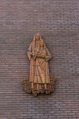 Netherlands, Delft, scupture of nuns on a wall