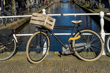 Fototapeta na wymiar Netherlands, Delft, cycle standing over a bridge