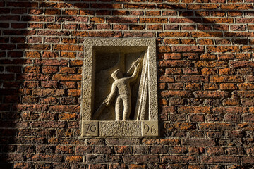 Netherlands, Delft, art work of a builder on a wall