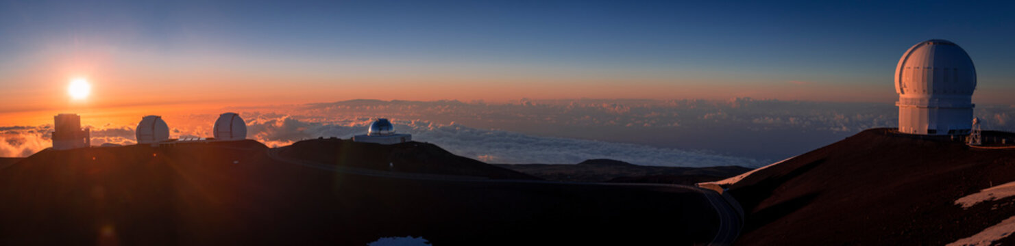 Panoramic view of the Mauna Kea summit with telescopes at sunet