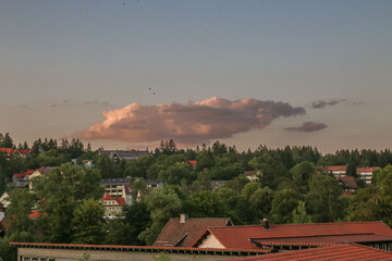 08-07-2023 - Braunlage, Harz, Germany. Here, a view of the small houses, up on the hillsides, heavy rain clouds, and dramatic clouds