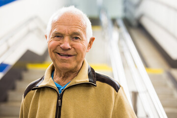 Portrait of old man going to metro station