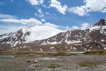 White snowy mountain peaks in the Barskoon Gorge in Kyrgyzstan, with views of the lakes