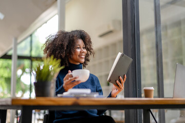 Young black woman resting mood with coffee and reading report.