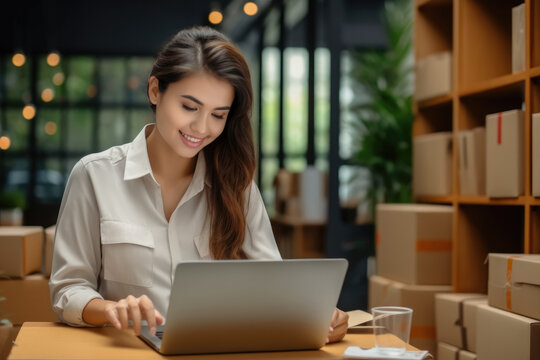 Startup small business SM, Young business woman working online e-commerce shopping at her shop, Seller prepare parcel box of product for deliver to customer, Online selling.