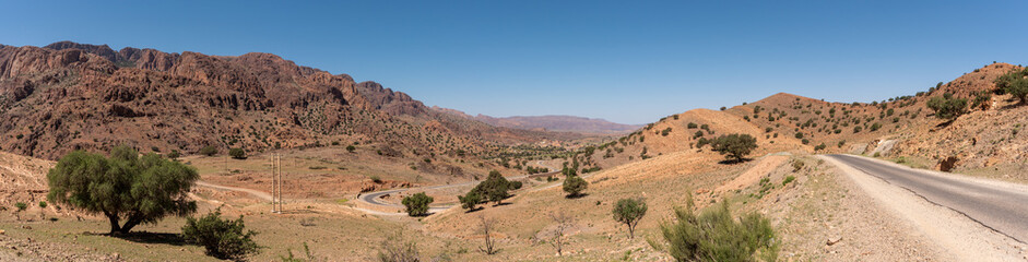 Fototapeta na wymiar Great panoramic landscape of the Anti-Atlas mountains in the Taourirt region, a road winding through the mountains