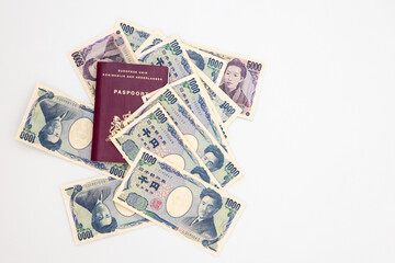 Obraz na płótnie Canvas Dutch passport and Japanese yen in banknotes of 1000 and 5000